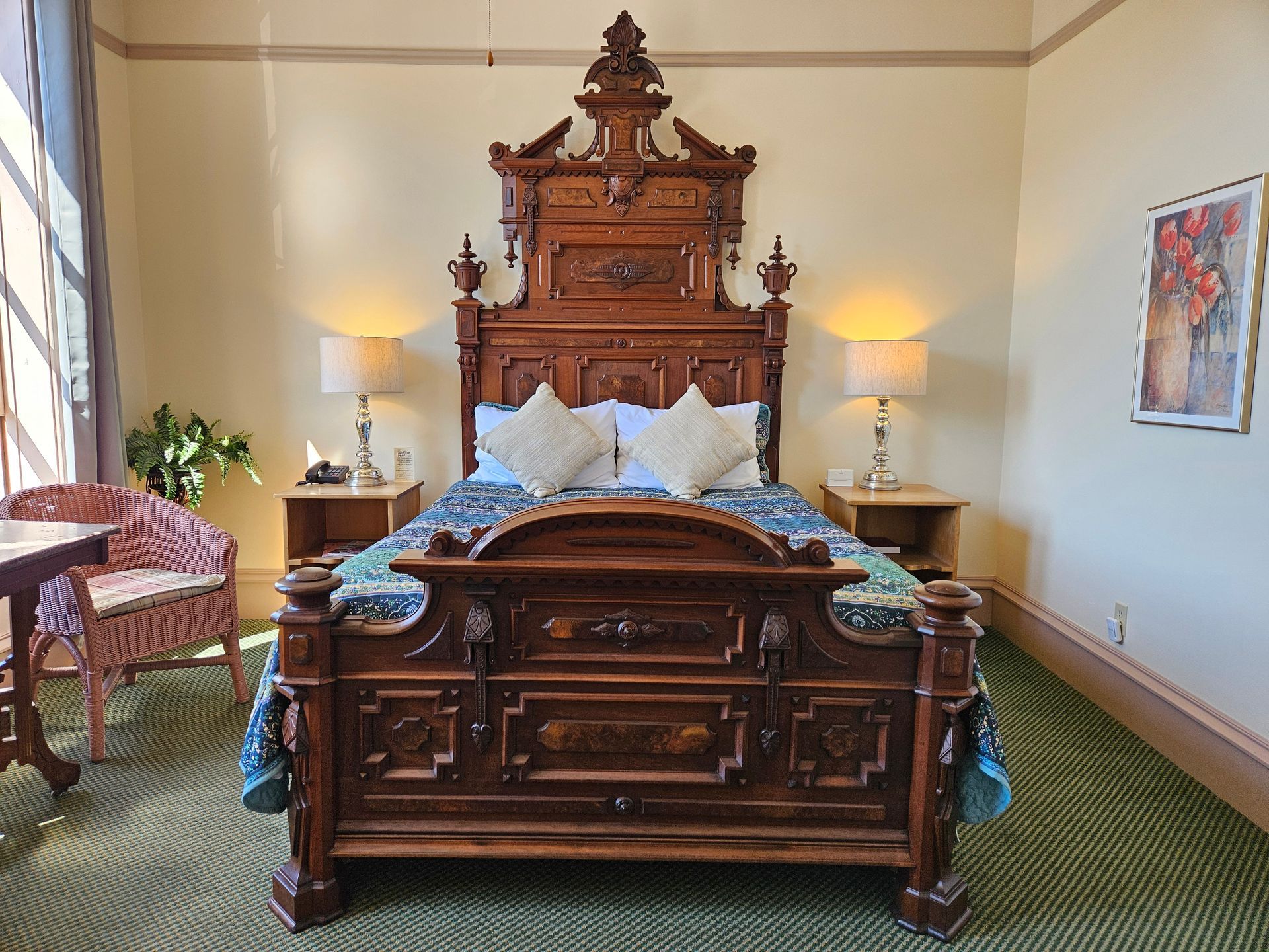 There is a large wooden bed in the middle of the room.