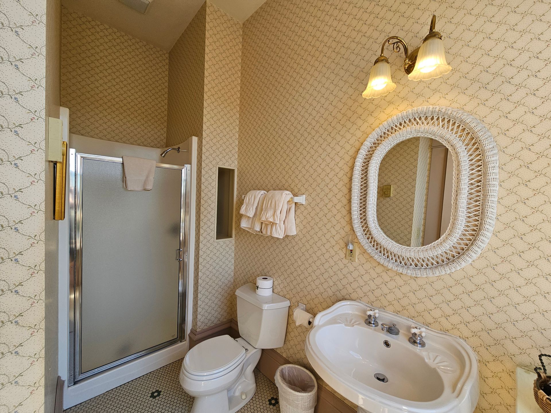 A bathroom with a toilet , sink and mirror