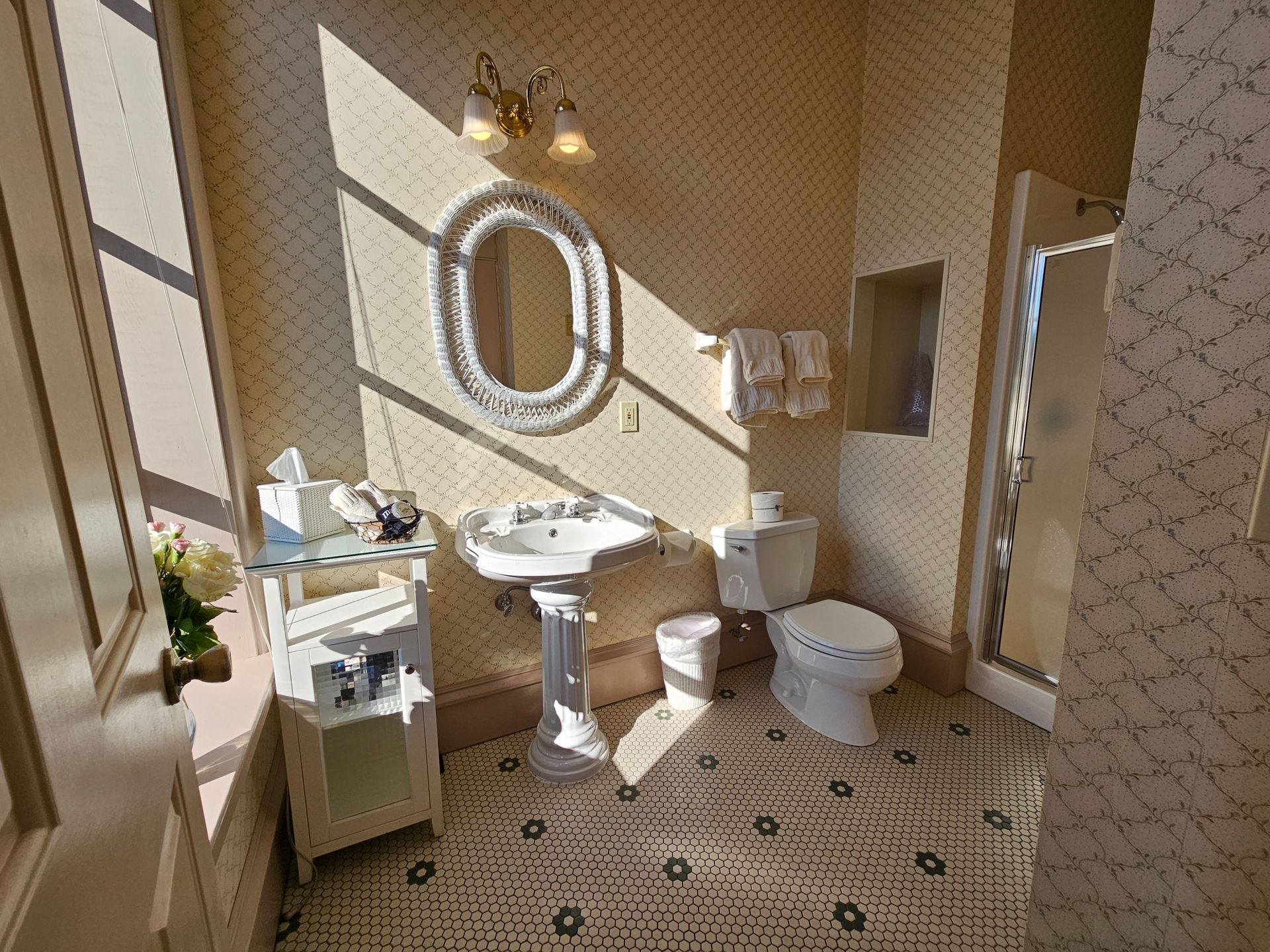 A bathroom with a sink , toilet , mirror and shower.