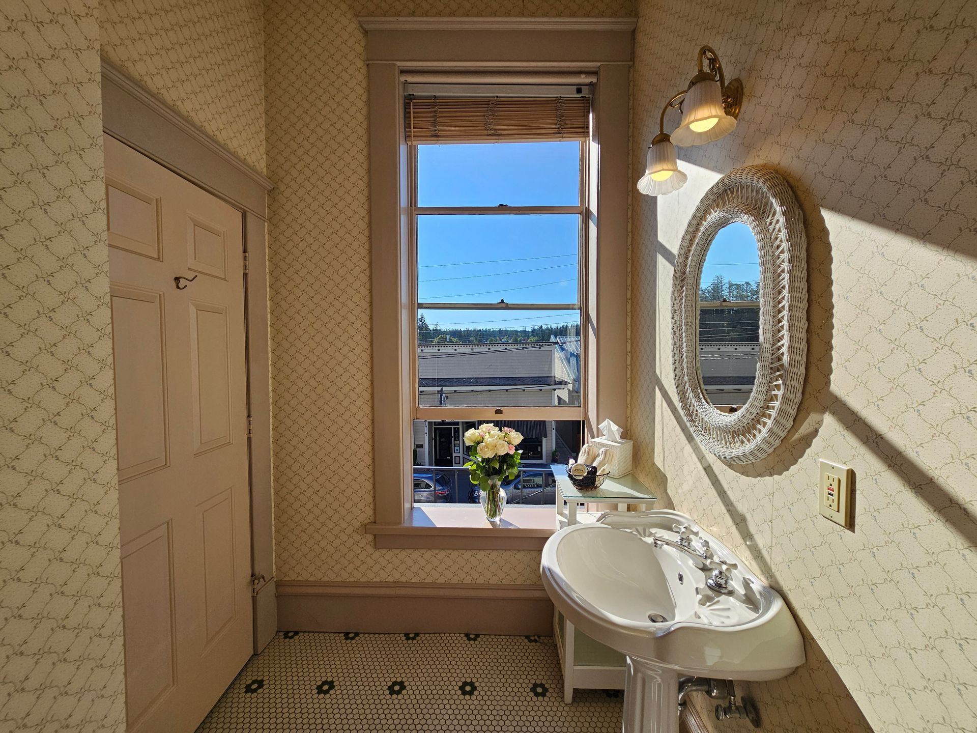 A bathroom with a sink a mirror and a window