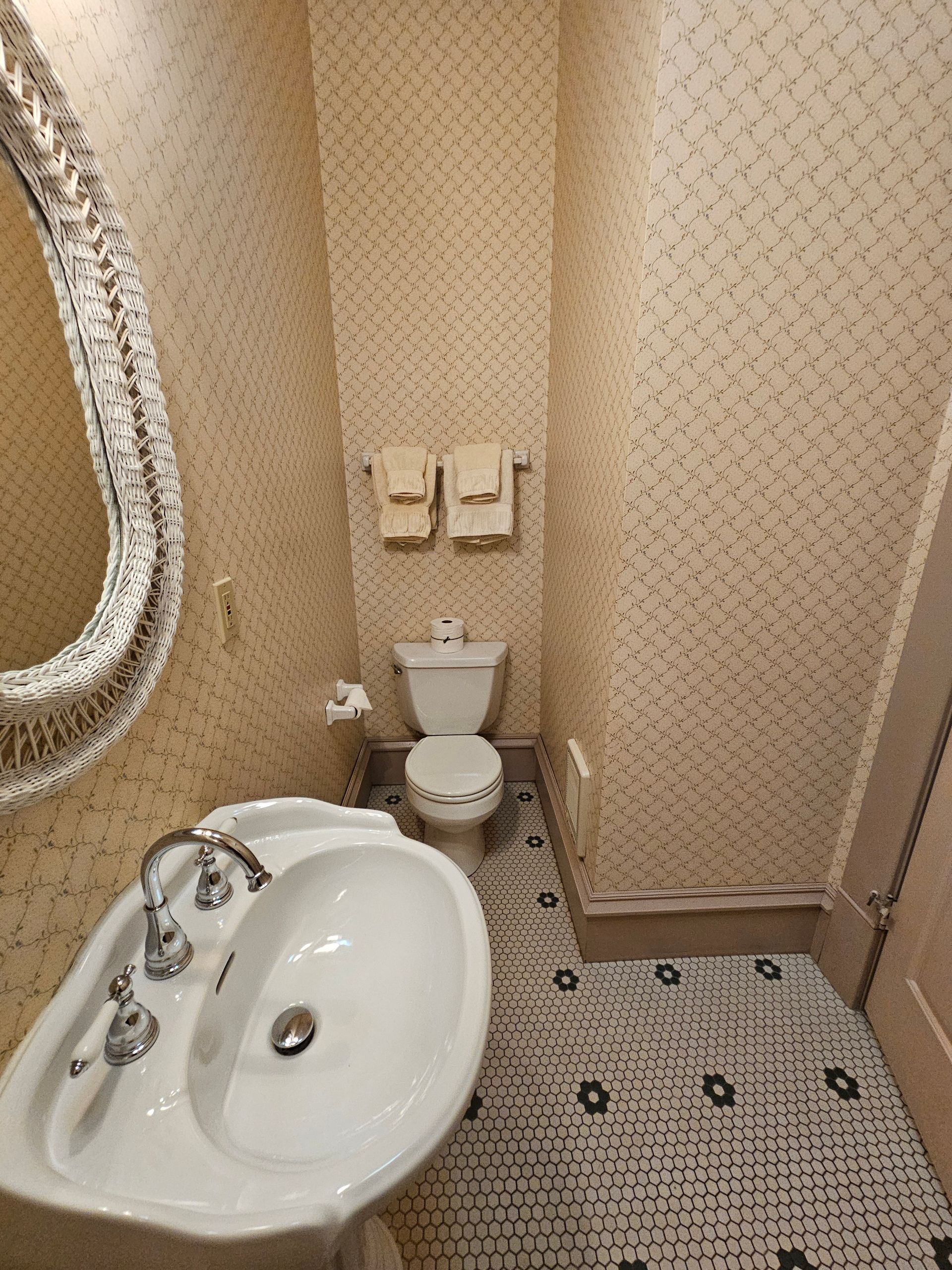 A bathroom with a sink , toilet and mirror.