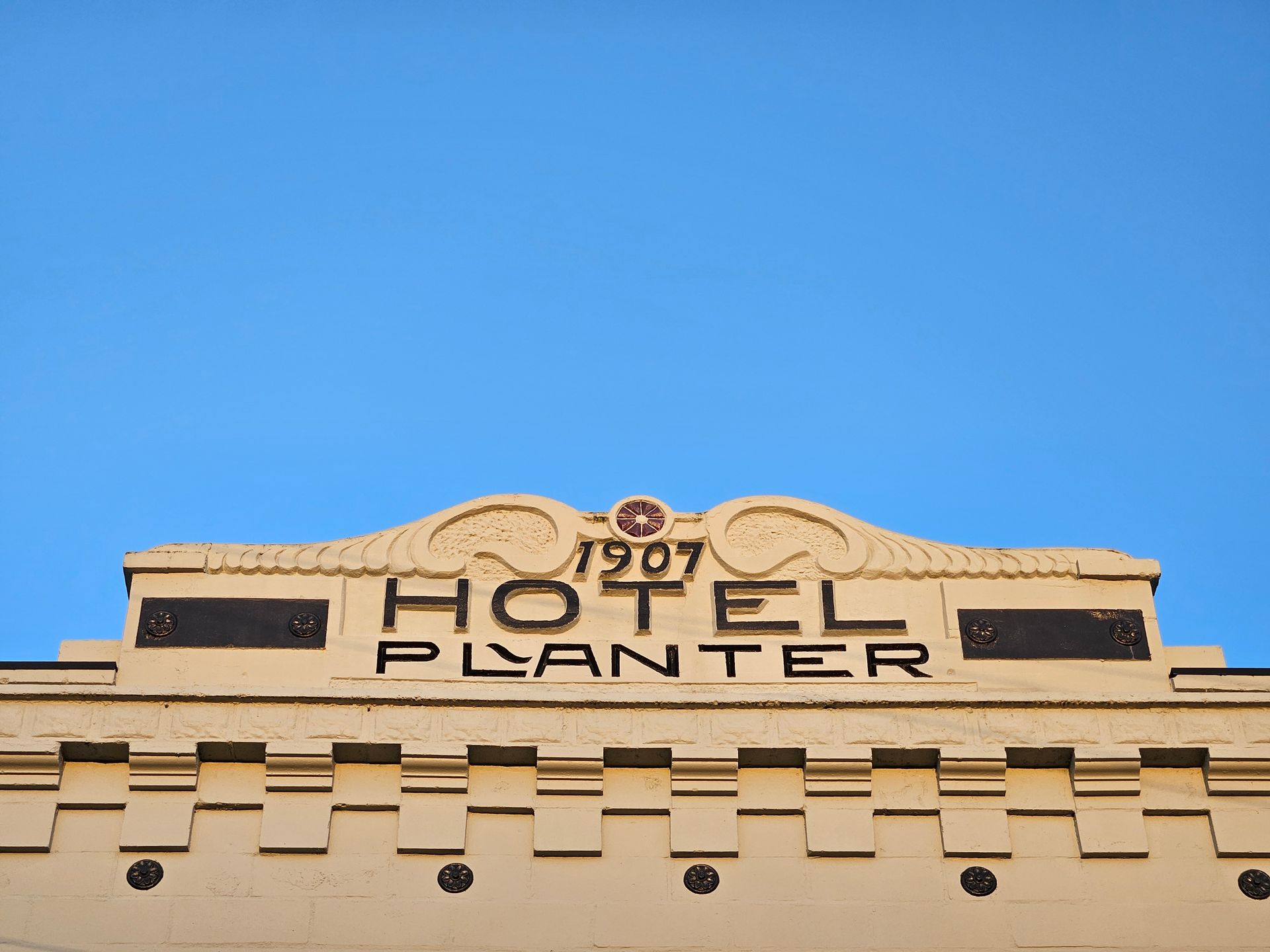 The hotel planter was built in 1907 and has a blue sky in the background