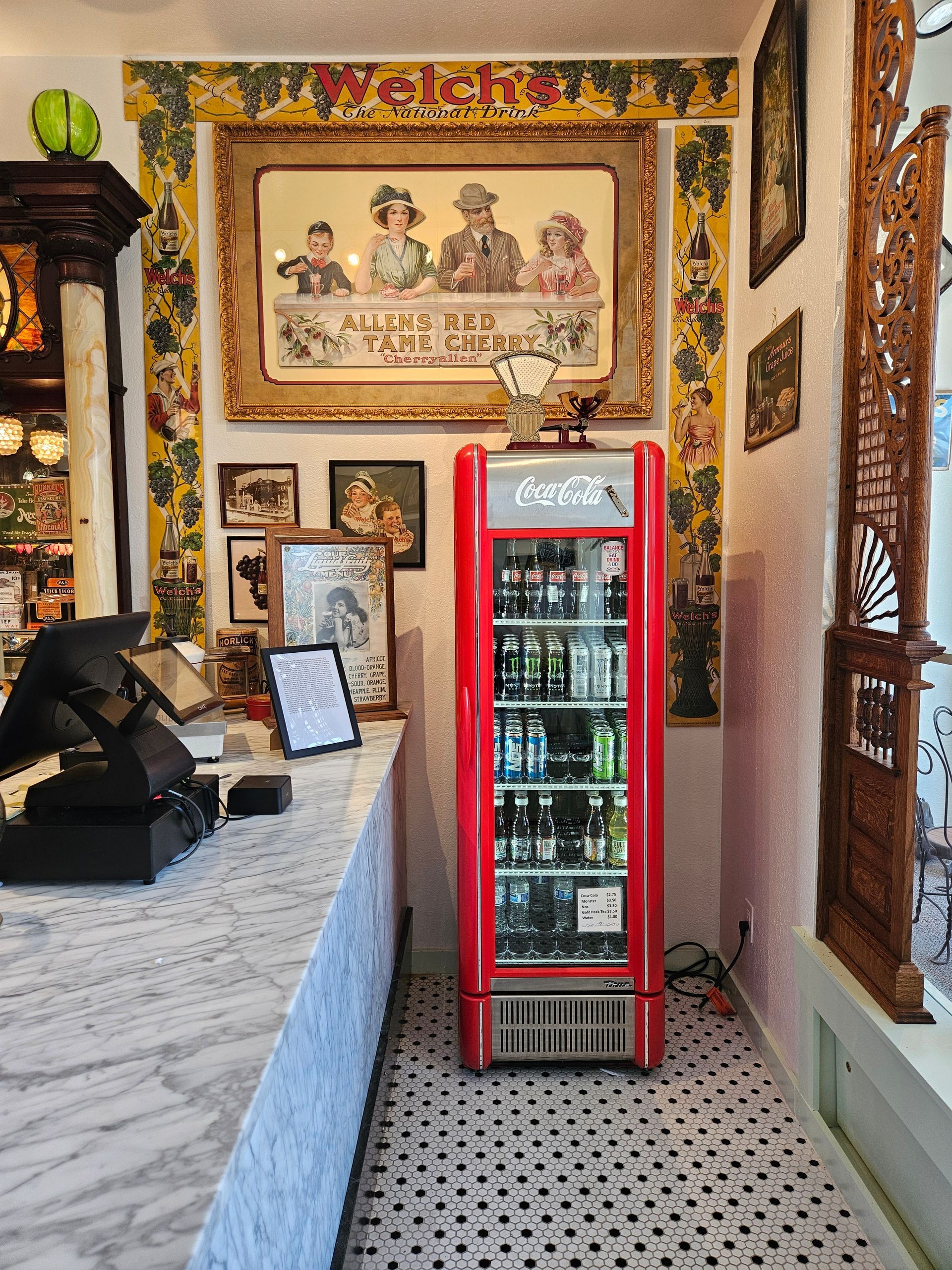 A red coca cola refrigerator is in a store.