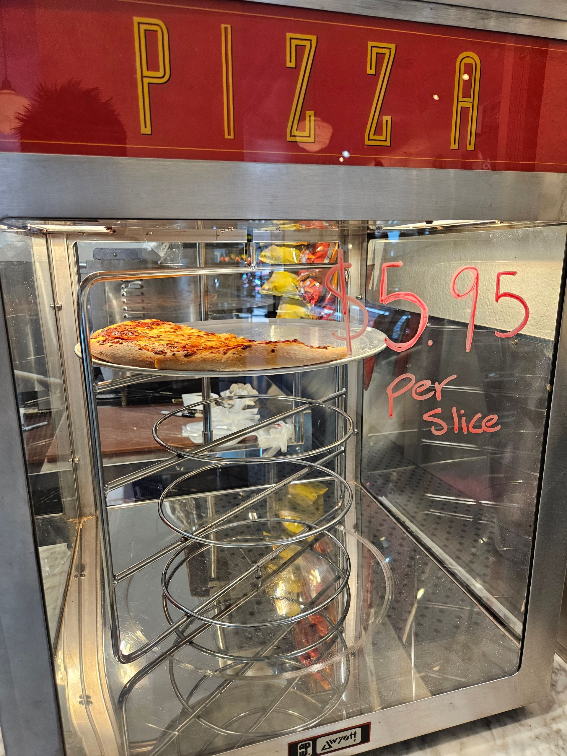 A pizza oven with a sign that says pizza on it