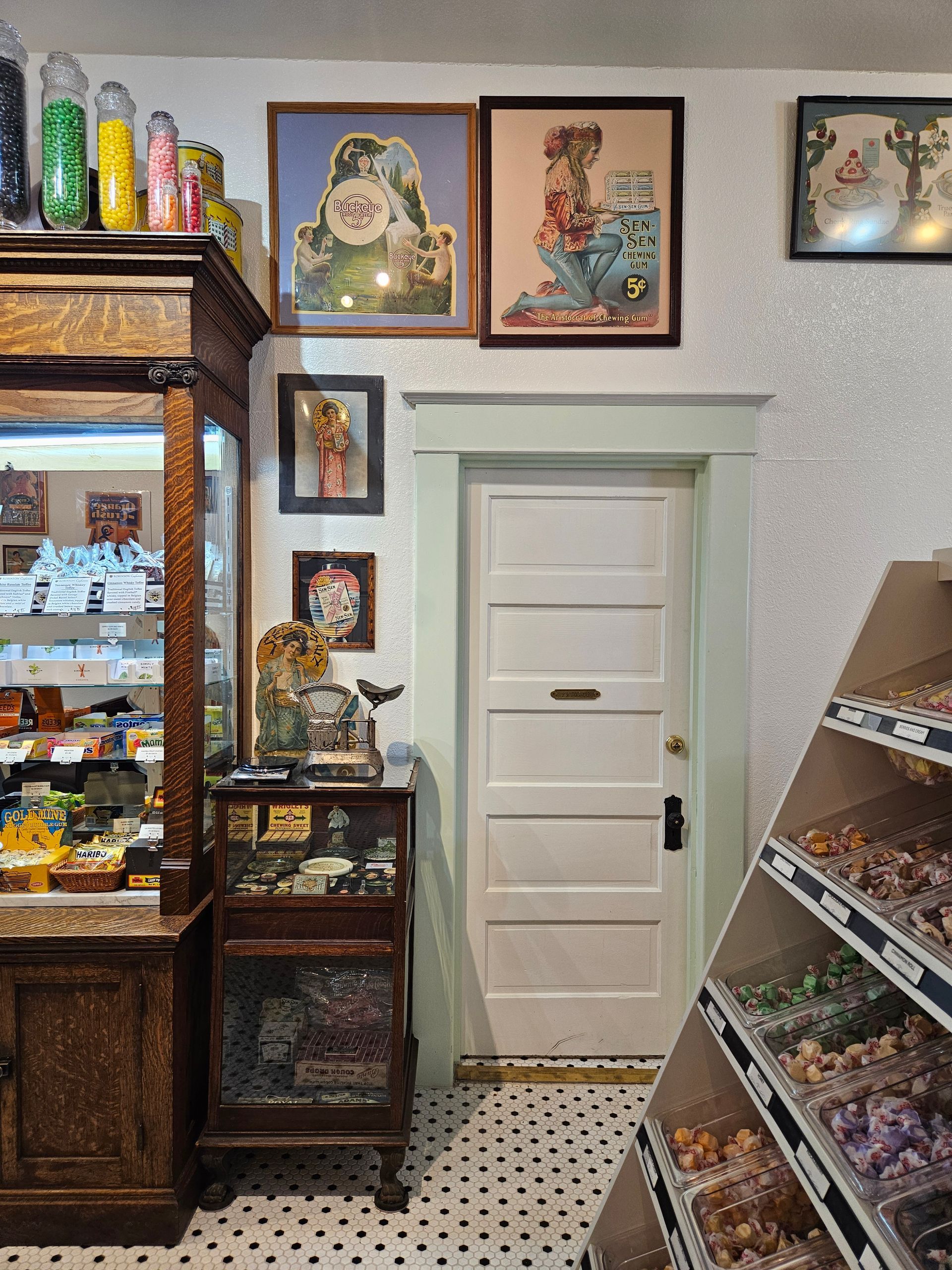 A candy store with a display case and a door.