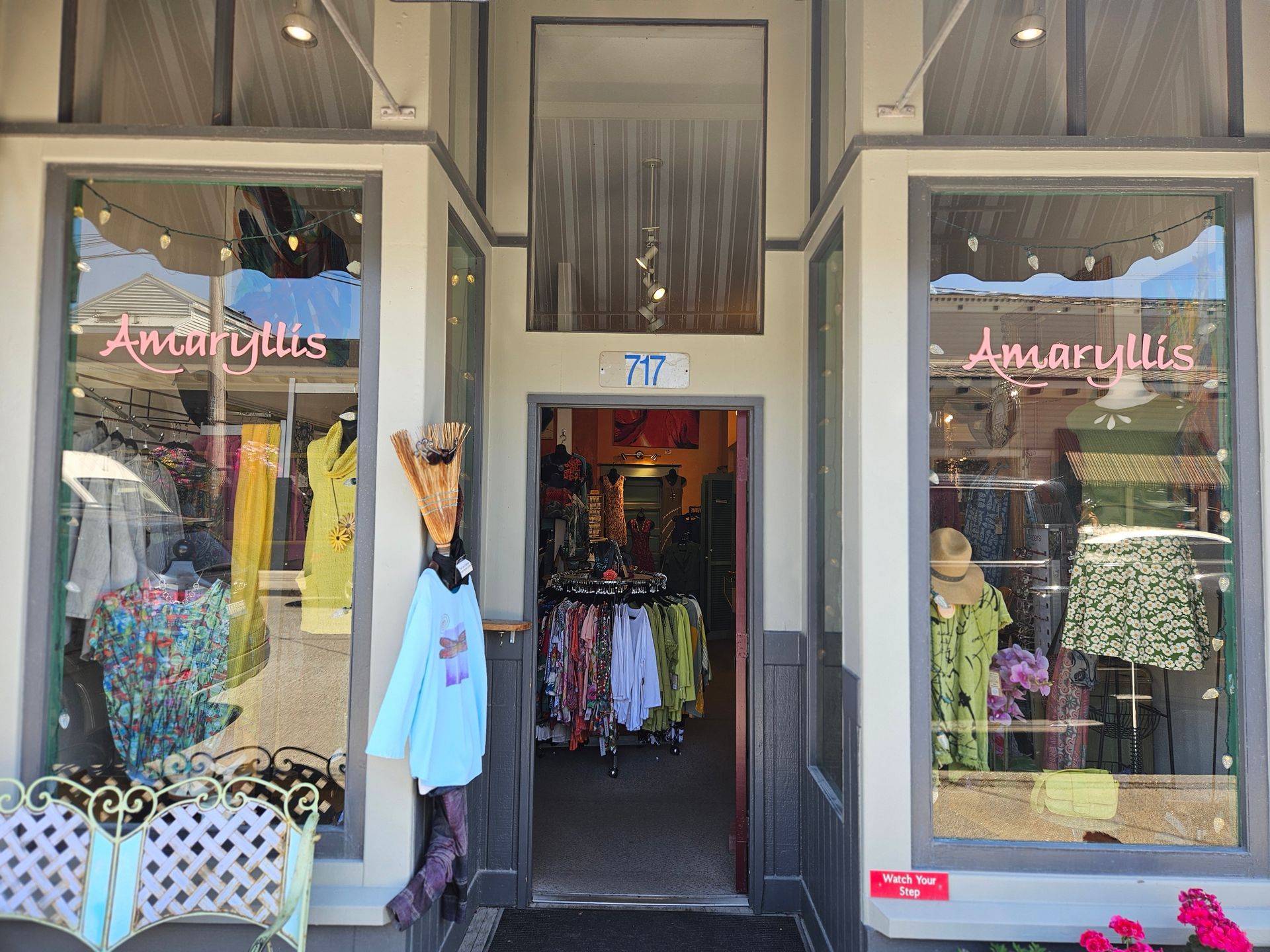 A store front with a giraffe statue in front of it.