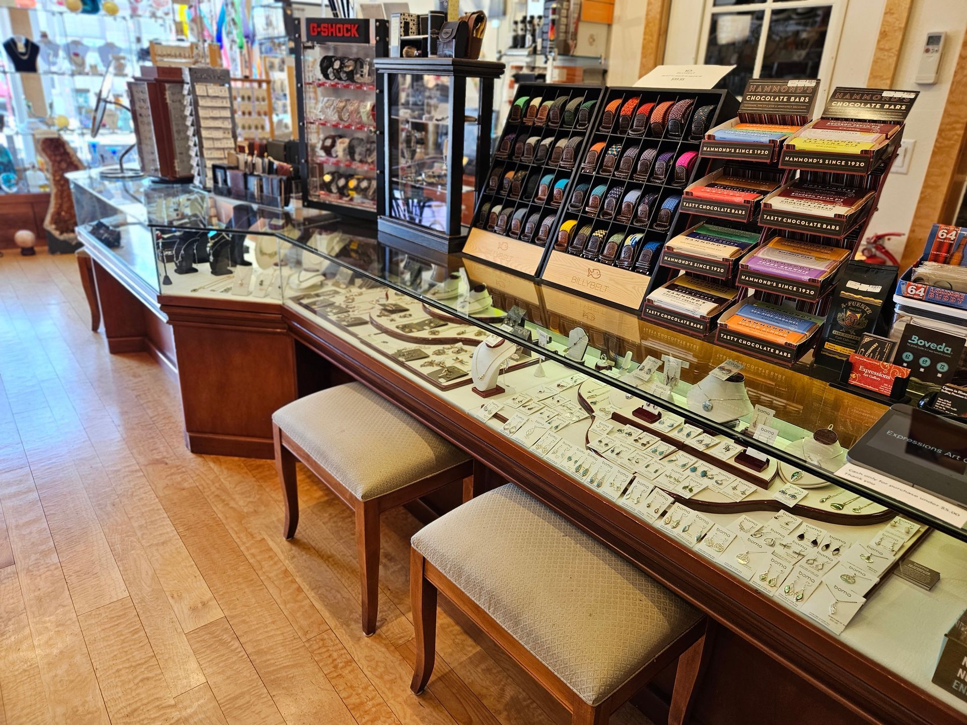 A jewelry store with a lot of displays and stools