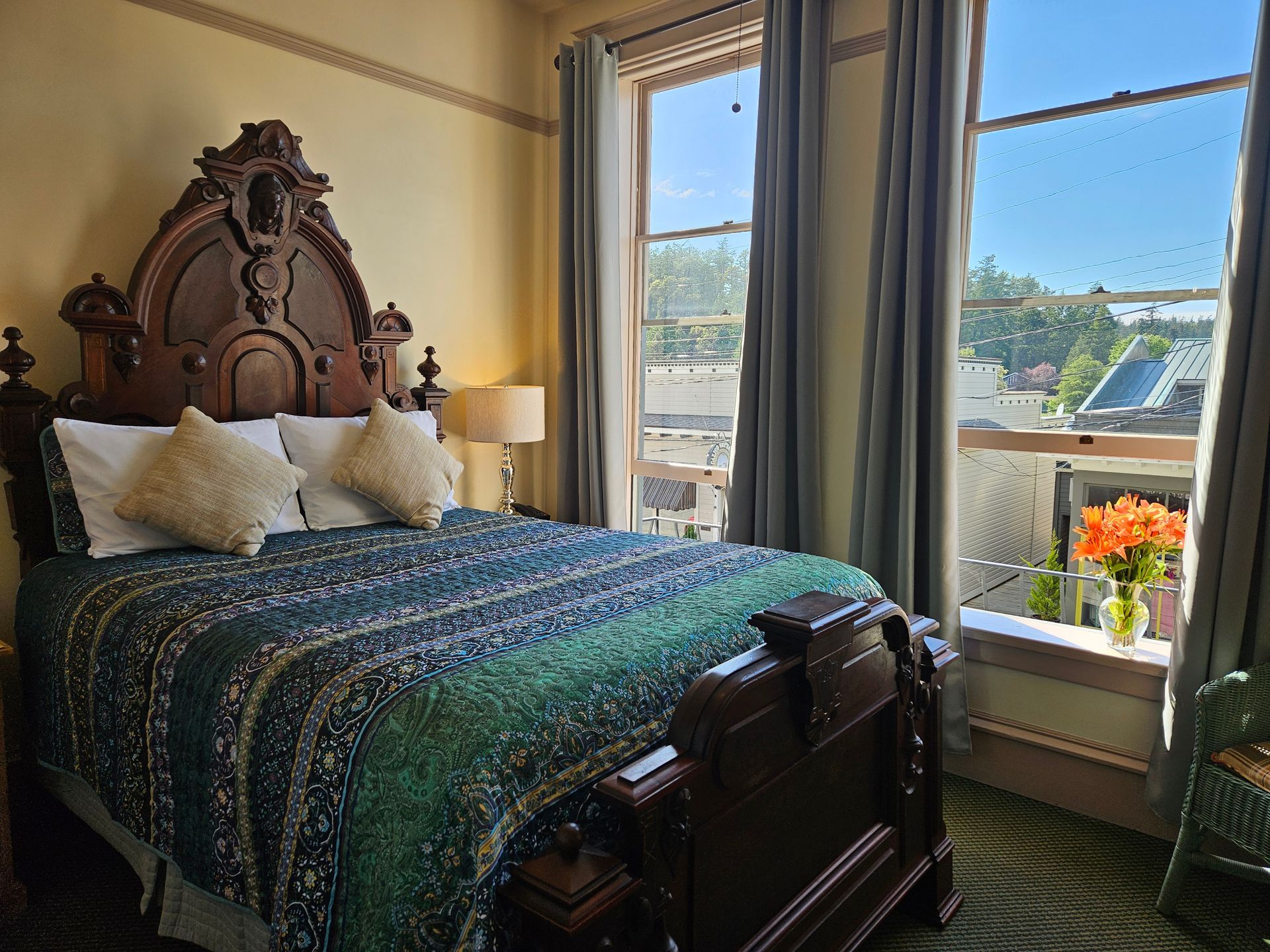A bedroom with a large bed and a ceiling fan