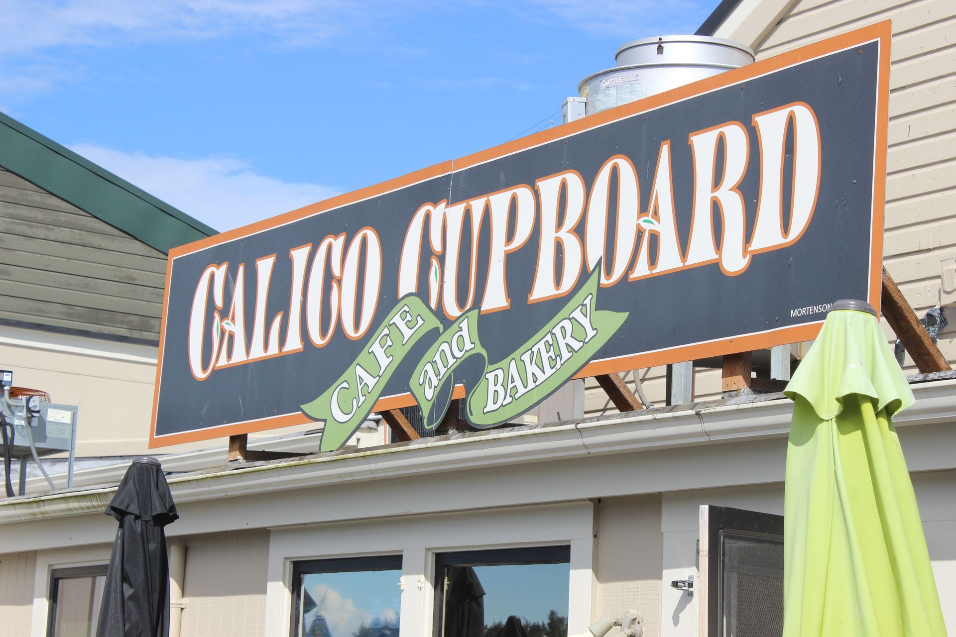 A sign for calico cupboard cafe and bakery