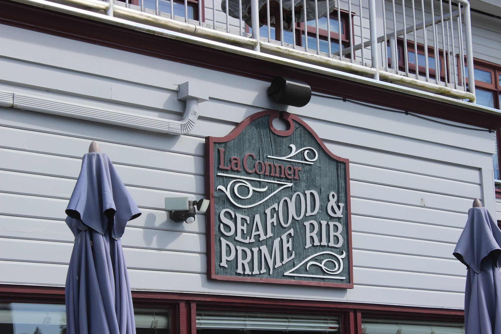 A sign on the side of a building says seafood and prime rib