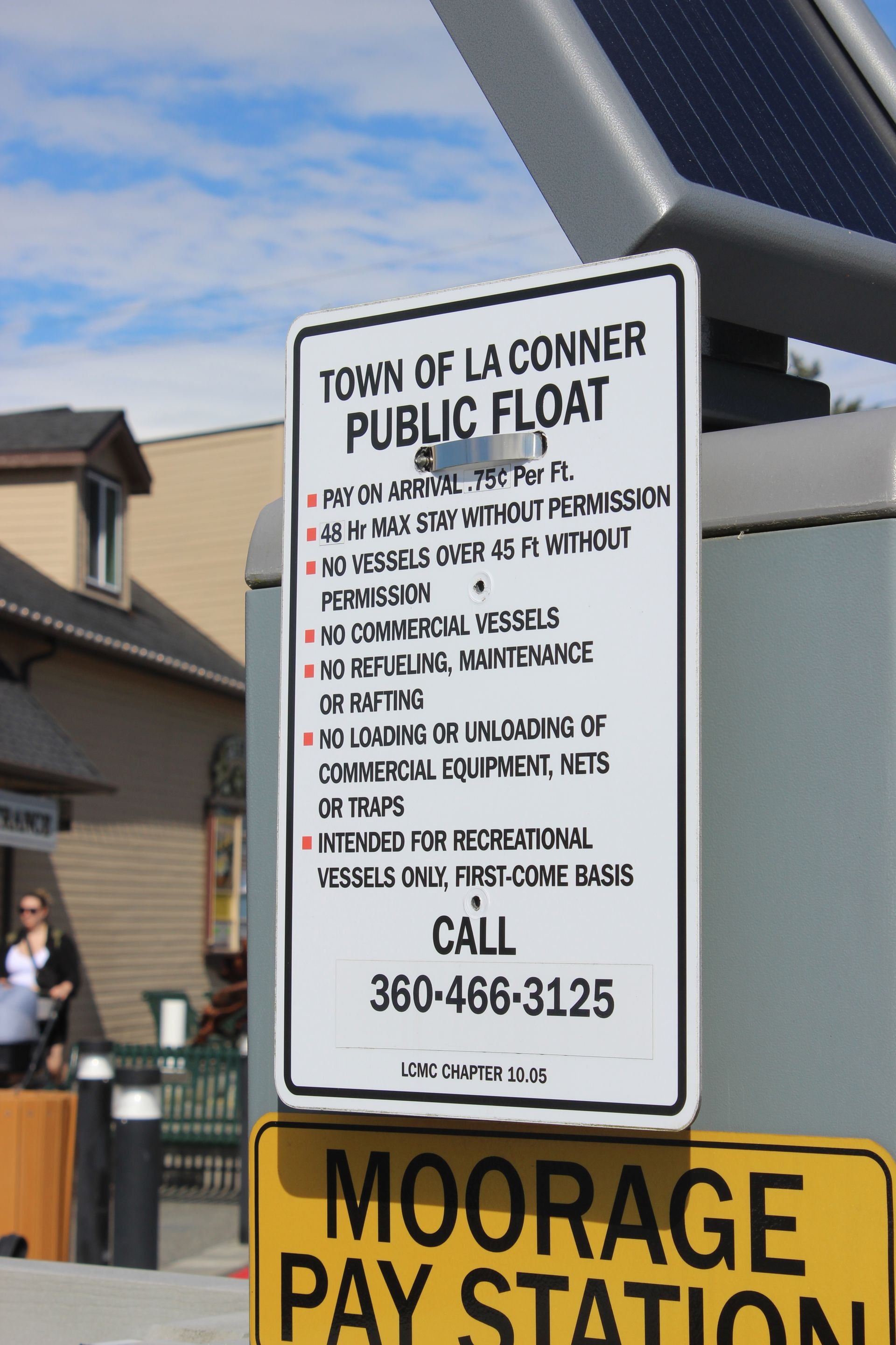 A sign for the town of la conner public float