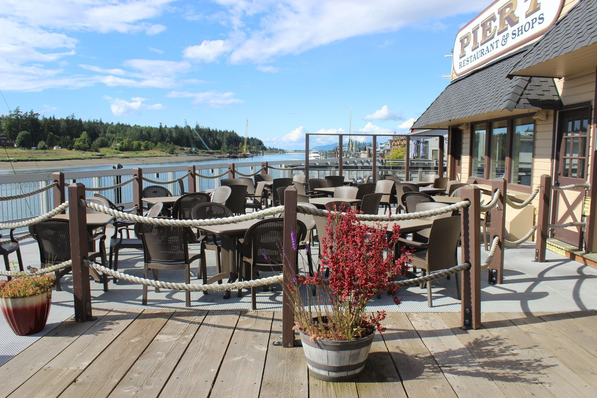 A dock with tables and chairs and a sign that says pier 1