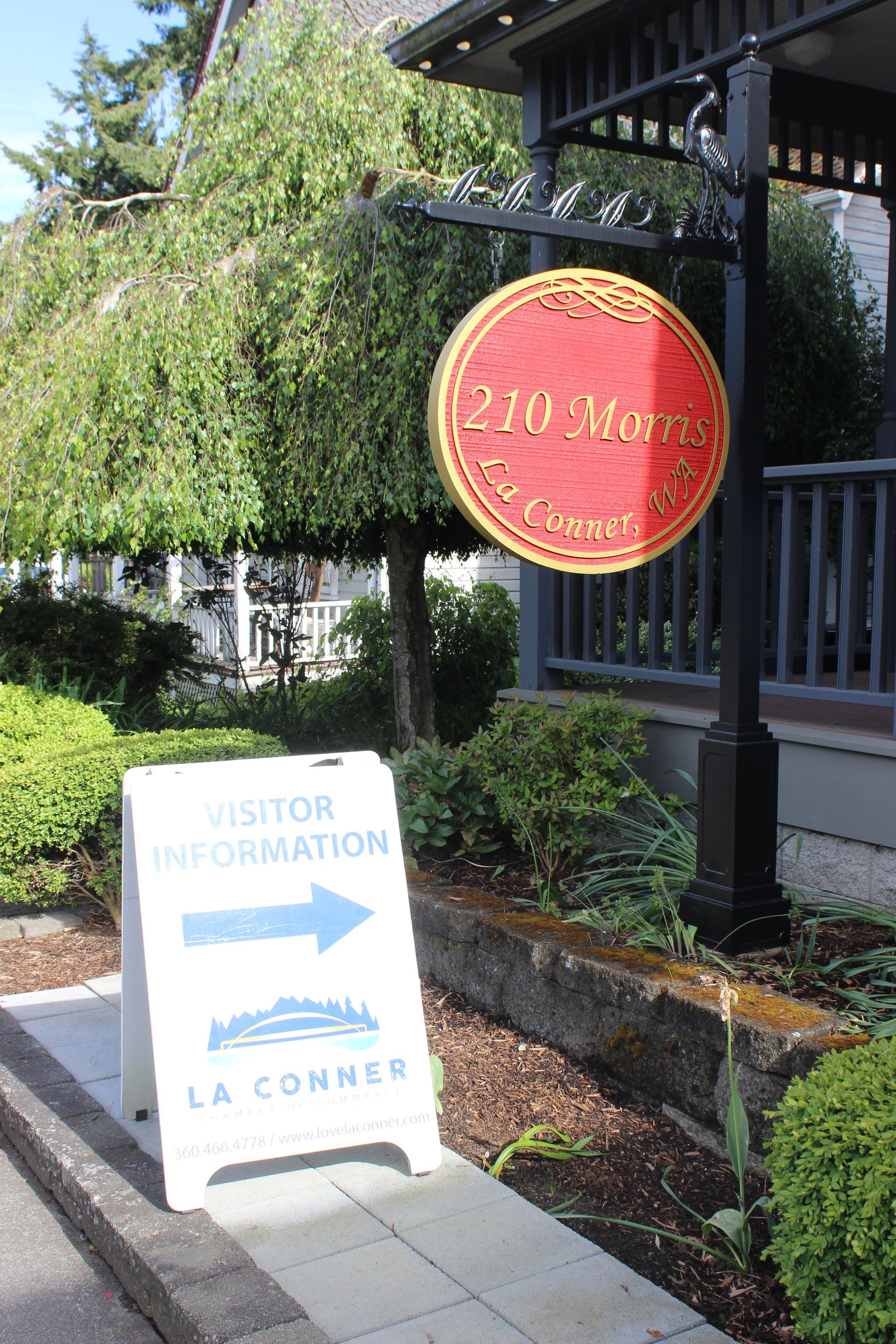 A sign that says visitor information is in front of a building.