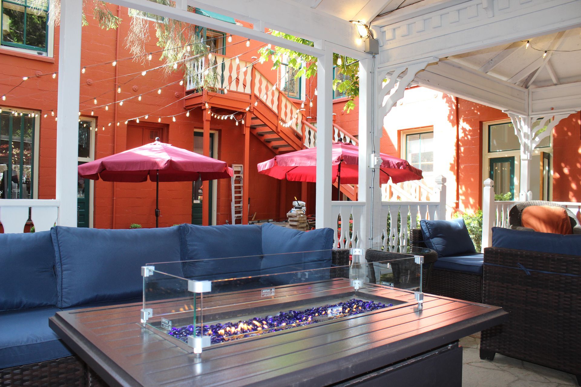 A gazebo with a fire pit in the middle of it