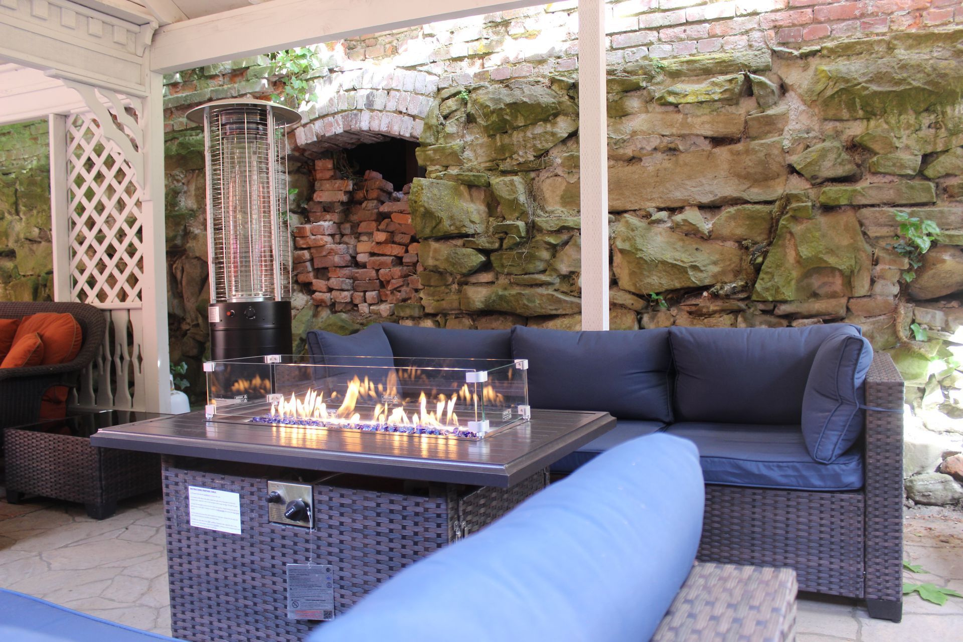 A patio with a fire pit and a couch