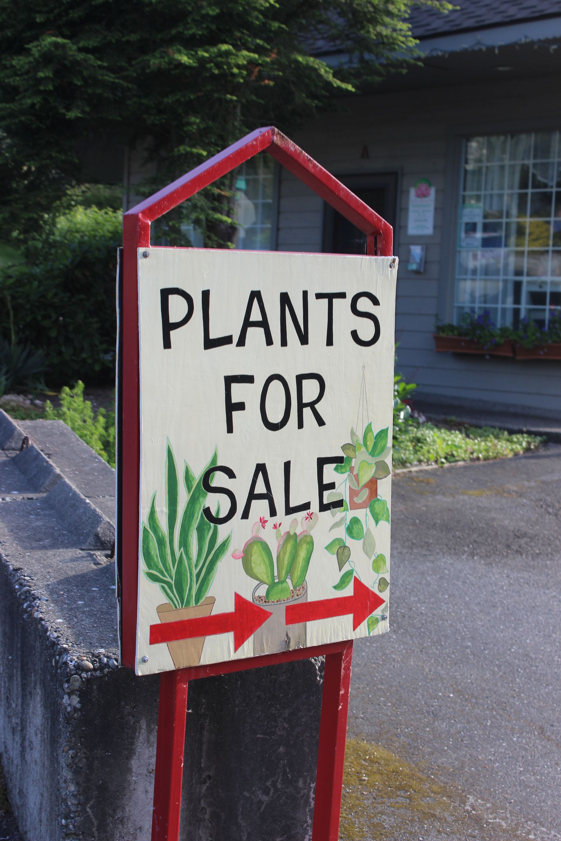 A sign that says plants for sale on it