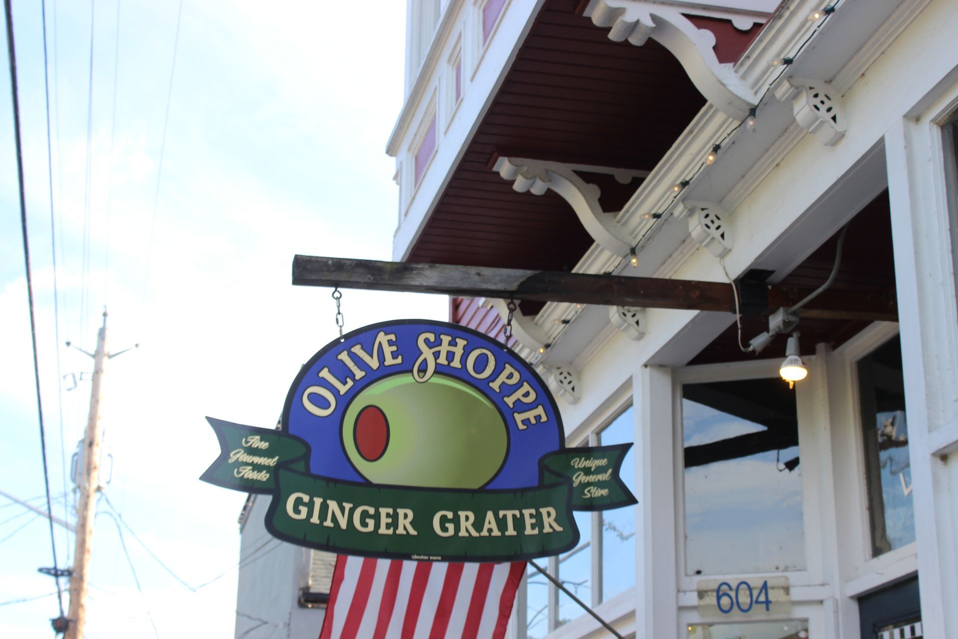 A sign for the olive shoppe ginger grater