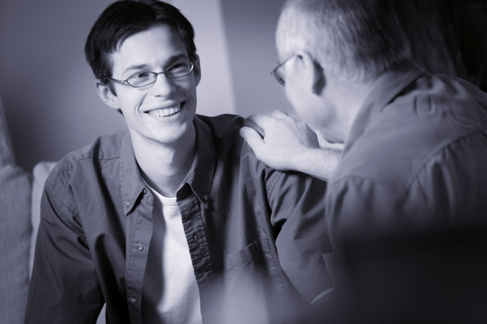 Two men are talking to each other in a black and white photo.