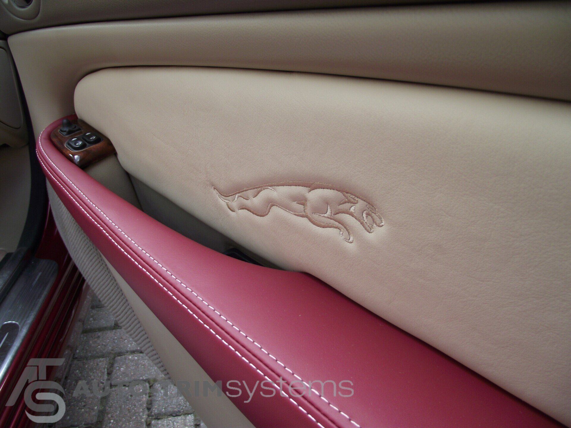 Jaguar doorcard in red and cream leather with embossed logo