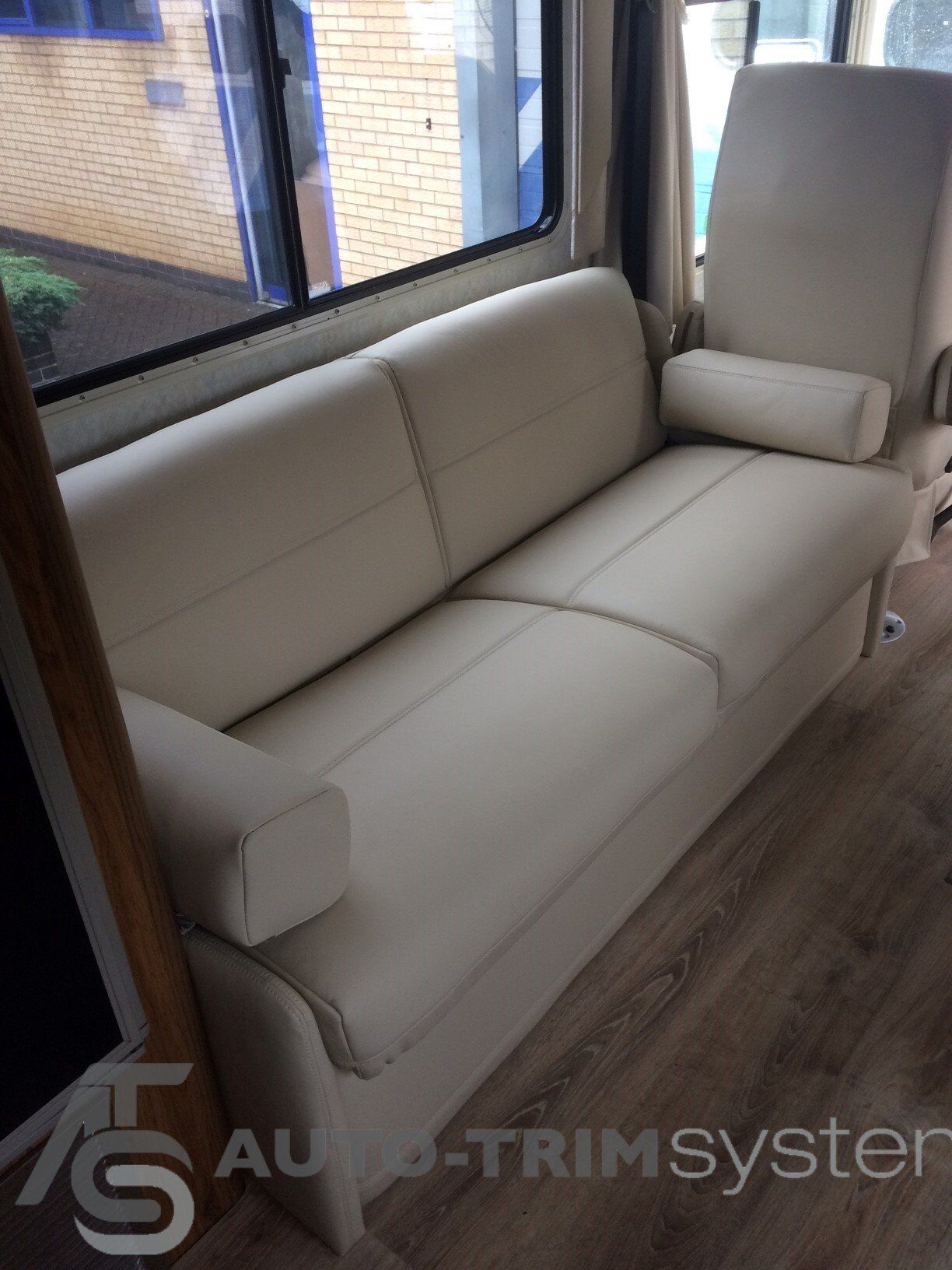 Winnebago with custom cream leather upholstered sofa bed