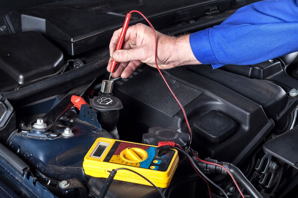 Mechanic Testing the Battery of a Car — Lynden, WA — Wayne’s Car Care Repair