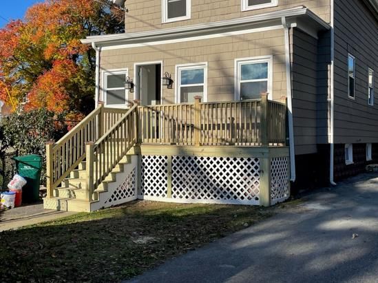 A house with a wooden deck and stairs