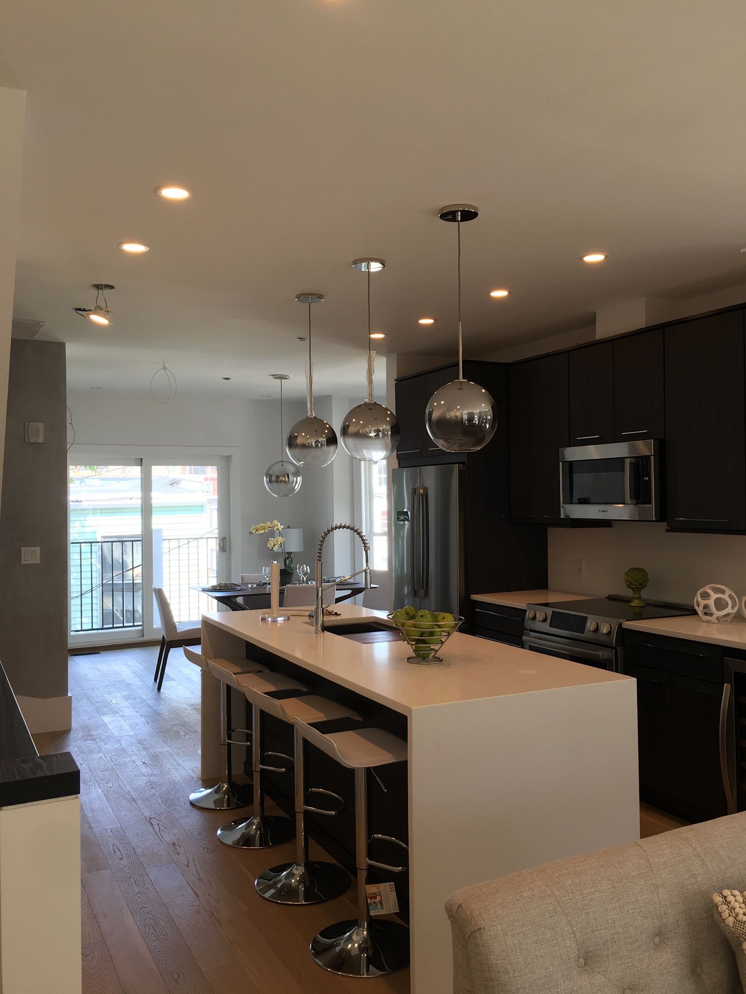 A kitchen with a large island and stools