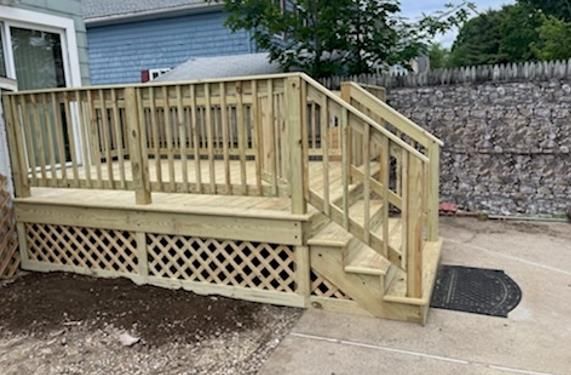 A wooden deck with stairs leading up to it.