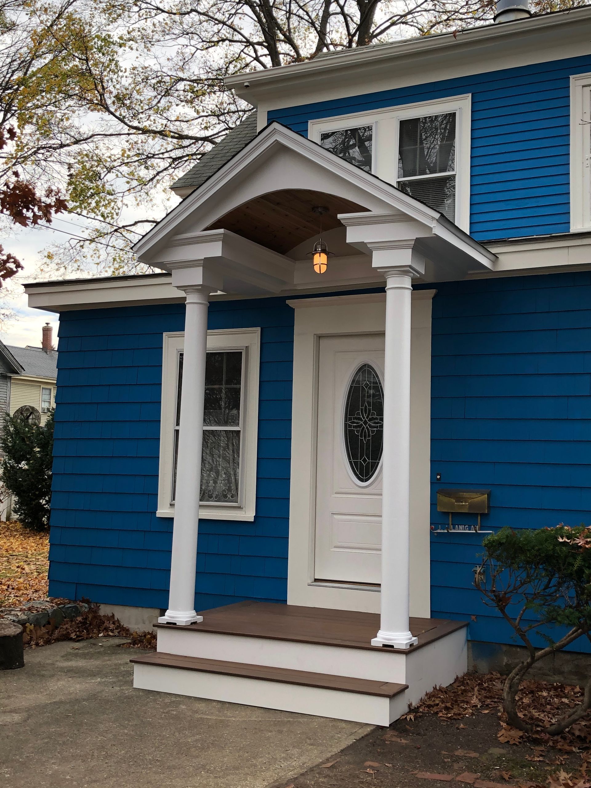 A blue house with a white porch and steps