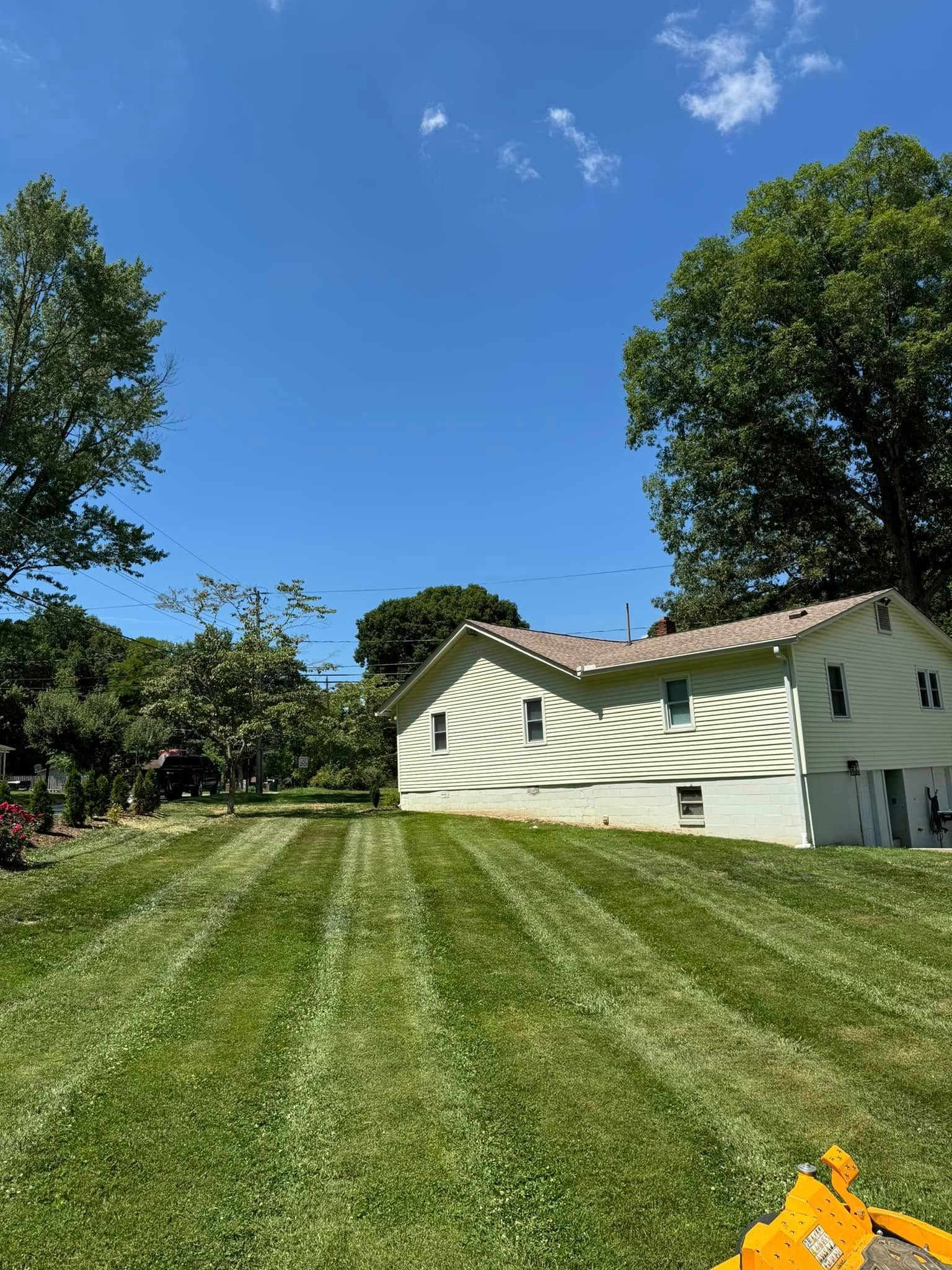 A house with a lush green lawn in front of it.