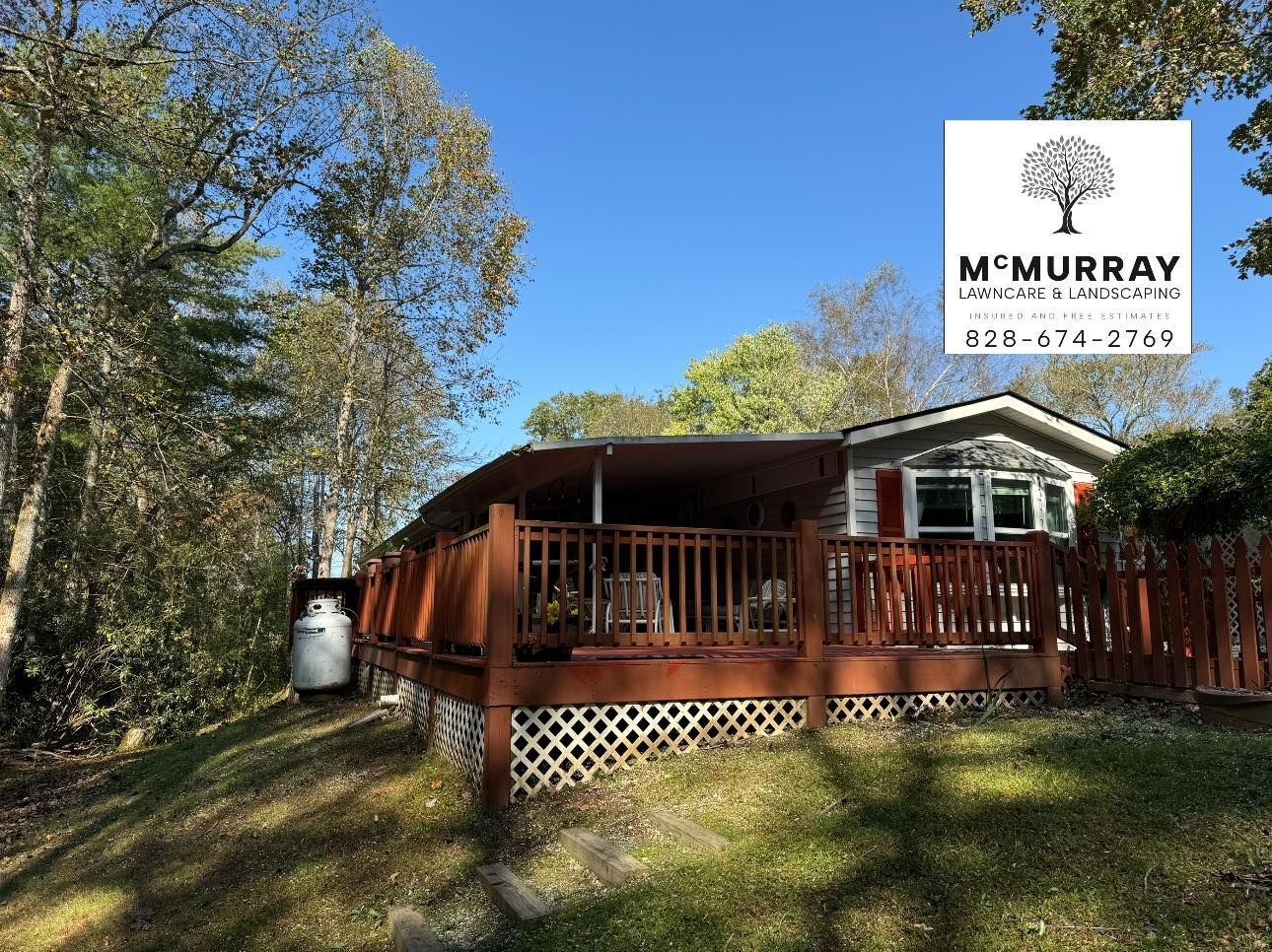 A mobile home with a large deck and a sign that says mcmurray