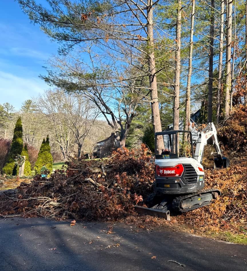 A yellow tractor is moving dirt on a construction site.