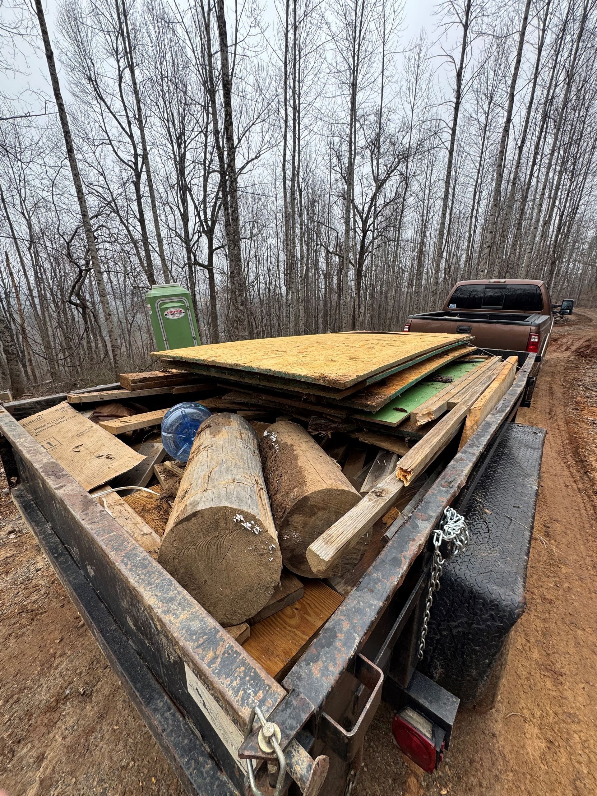 A pile of garbage is on the sidewalk in front of a building