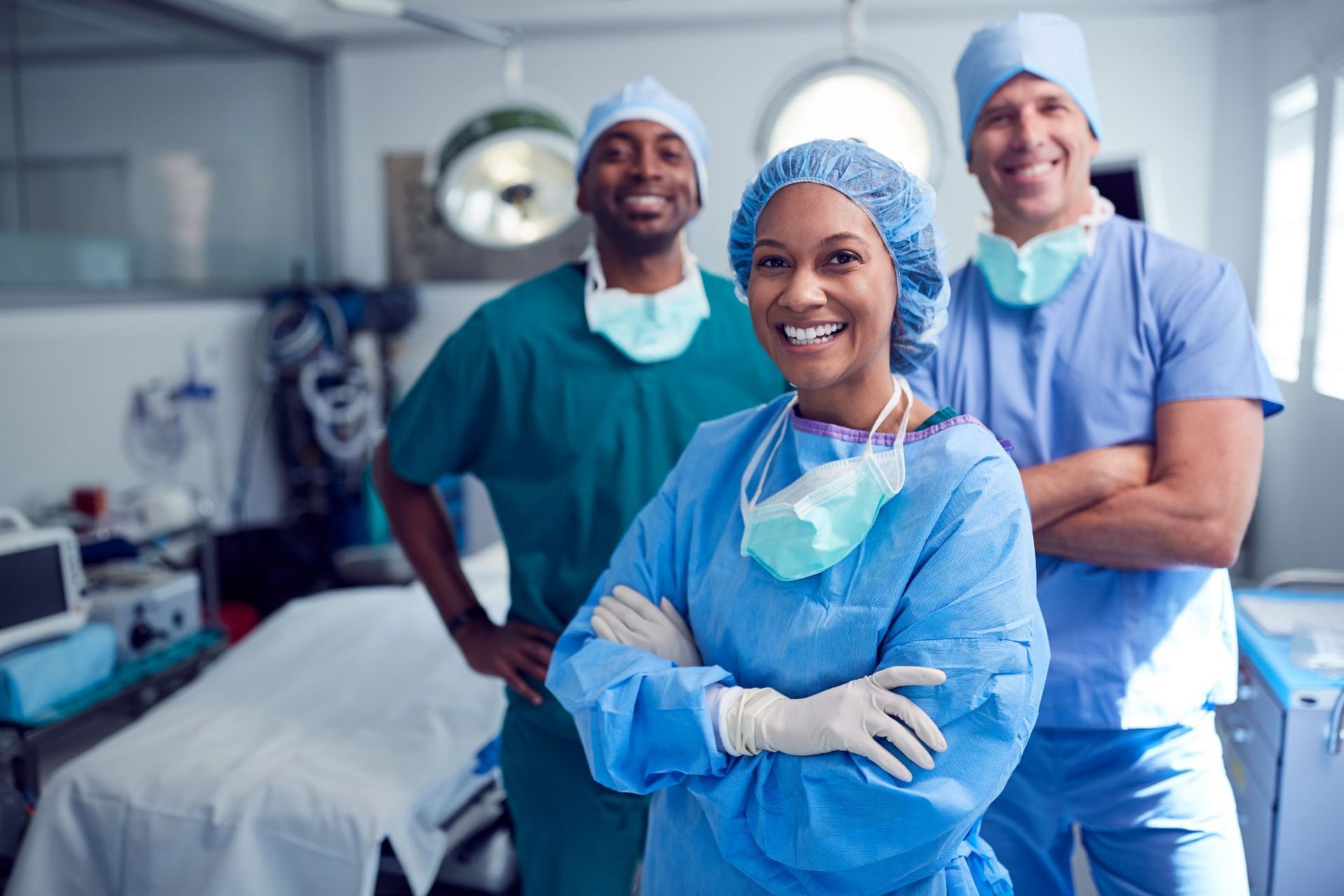 smiling group of diverse anesthesiologists in surgery room