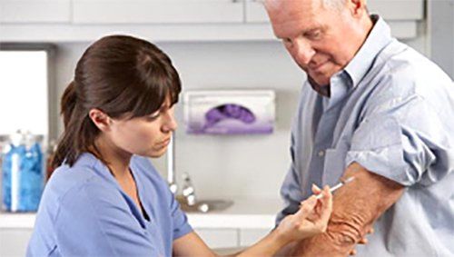 Nurse injecting medicine to the patient