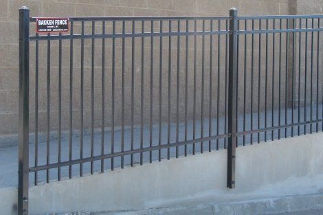 A metal fence with a sign on it that says safety fence