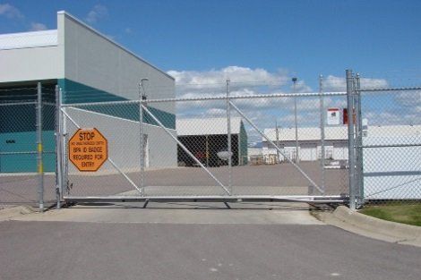A sliding gate with a stop sign on it