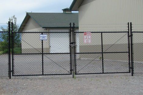 A chain link fence with a warning sign on it