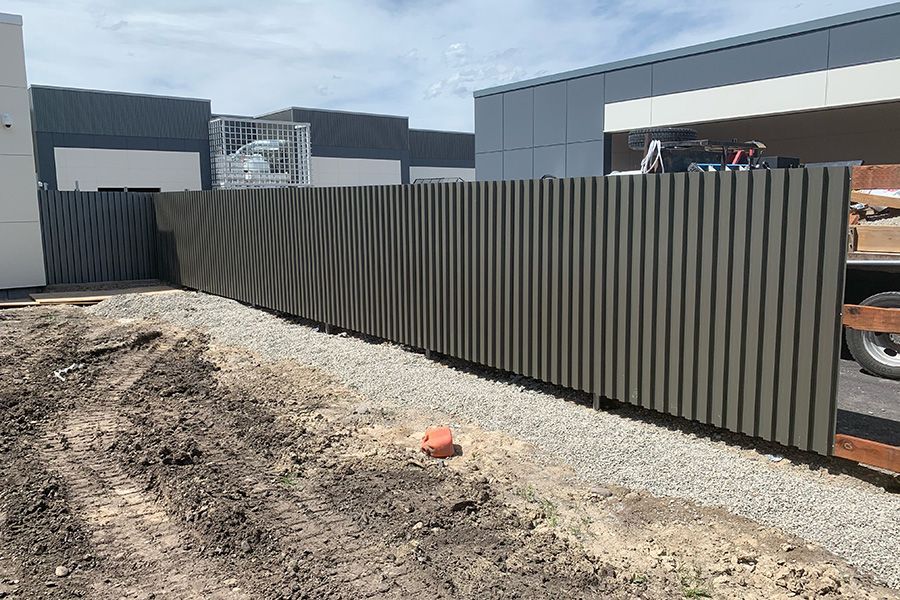 A fence is being built in front of a building.