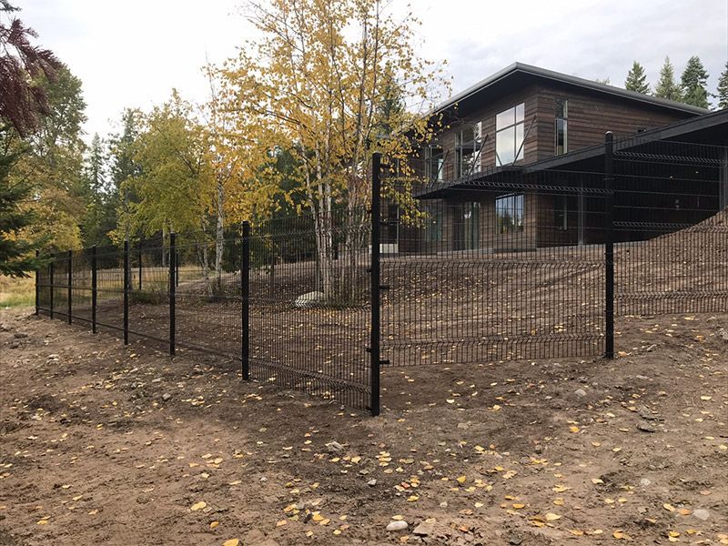 A large house with a fence in front of it.