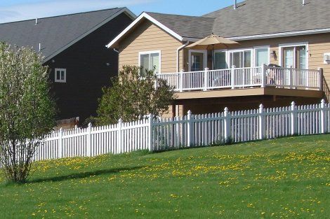 A house with a white picket fence in front of it