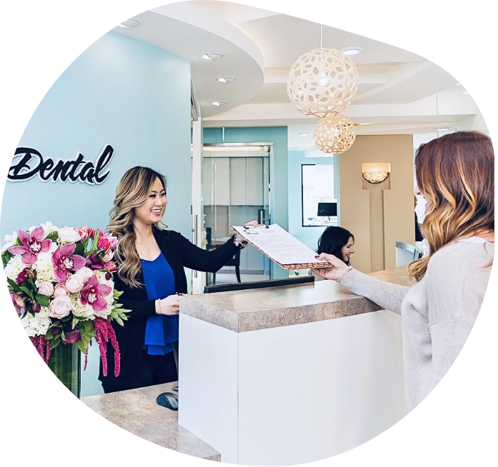 A patient is greeted at the front desk by one of Oceanic Dental's friendly staff.