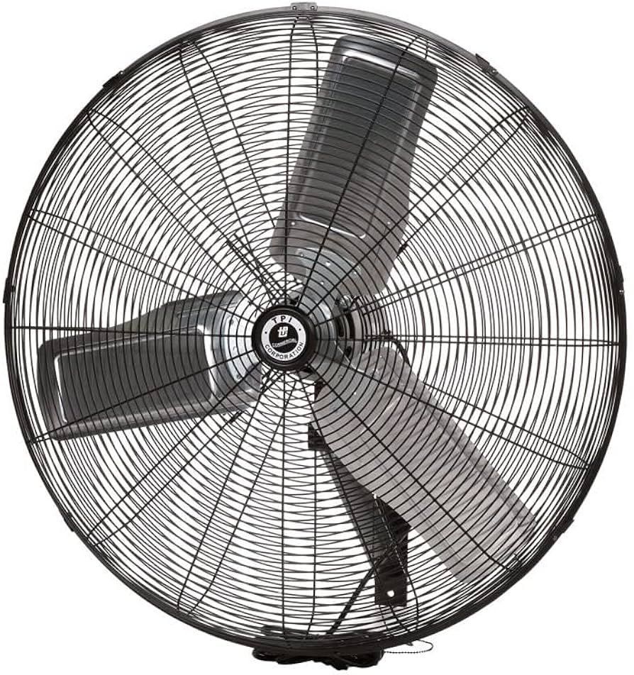 A large wall mounted fan with three blades on a white background.