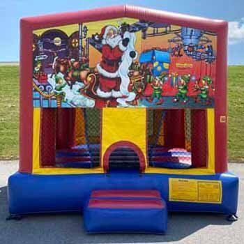 A bouncy house with a picture of santa claus and snoopy on it.