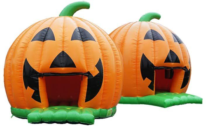 Two inflatable pumpkins with faces on them are sitting next to each other on a white background.