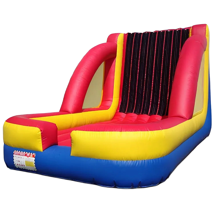 A red yellow and blue bouncy house with a warning label on it