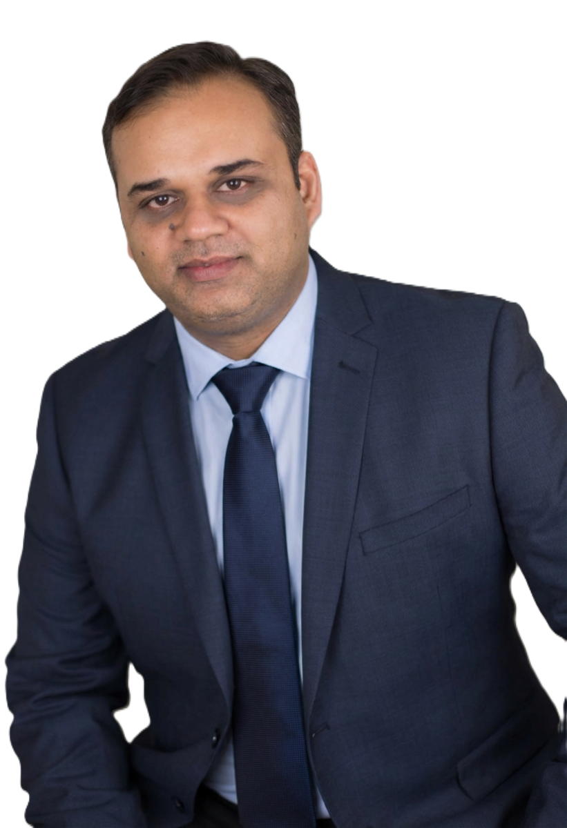 Man in a blue blazer and light blue shirt, looking toward the camera. White background.
