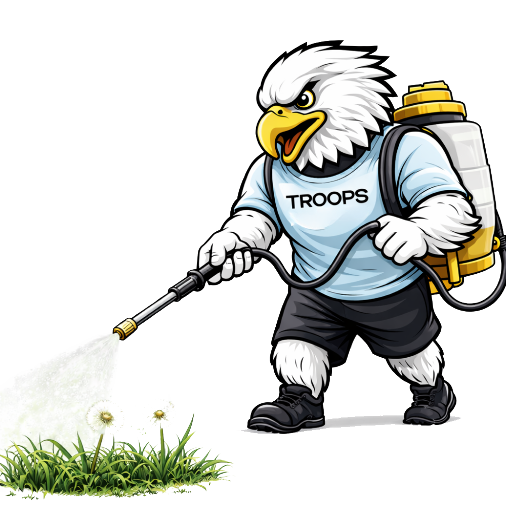 Mascot spraying on grass.