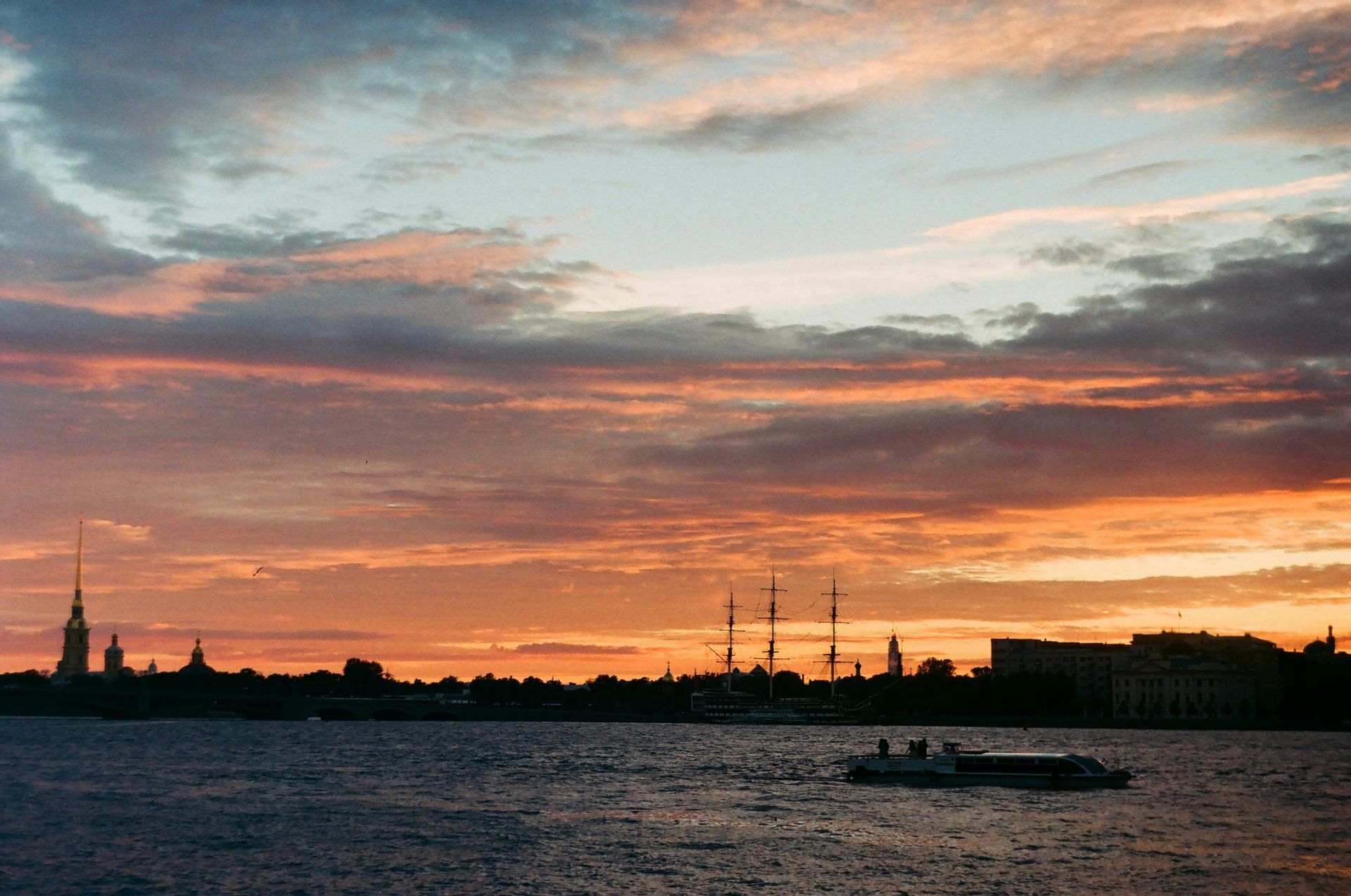 A sunset over a body of water with a city in the background