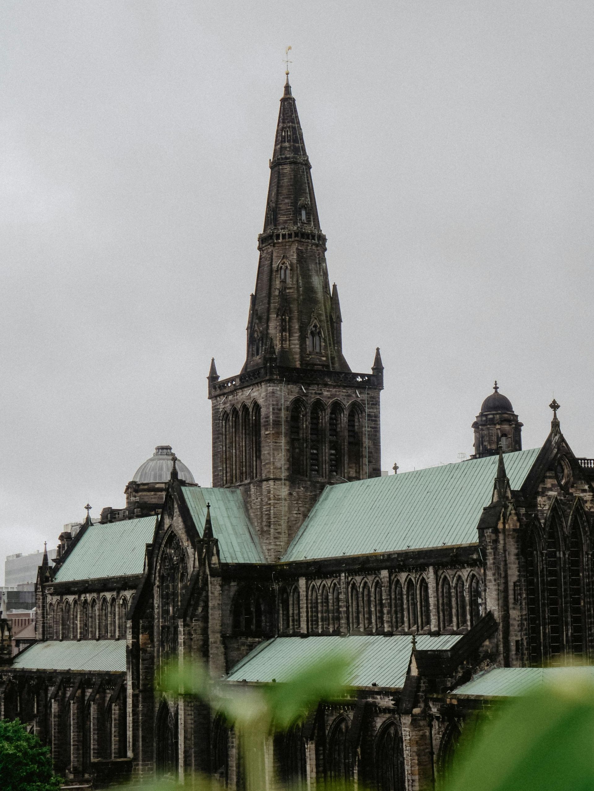 A large building with a green roof and a steeple